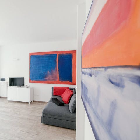 See the minimalist white space come to life with bold abstract art
