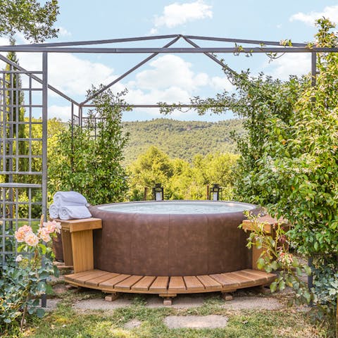 Watch the sun set over the hills from the comfort of the outdoor hot tub