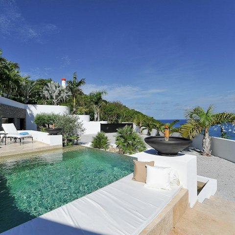 Cool off in the pool with the bay spread out below