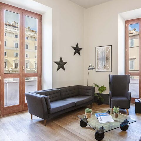 Relax and unwind in the light-filled living area, after a day of exploring all that Rome has to offer