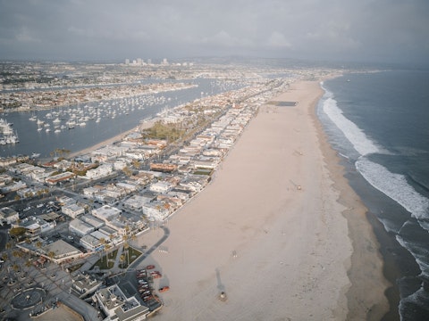 Enjoy miles of wide Pacific shoreline on Balboa Peninsula's iconic stretch, a fifteen-minute drive