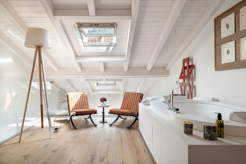 Soak in the rooftop loft bathtub beneath open skylights