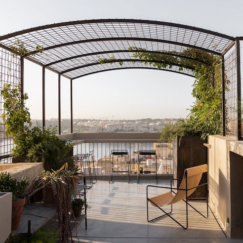 Head up to the shared terrace and watch the sun set over the water