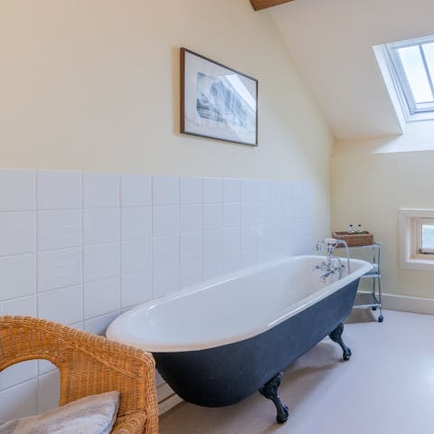 Sink back into piping hot water in the clawfoot bathtub