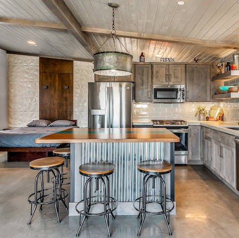 Rustle up a delicious feast in the modern kitchen – we love the concrete countertops and big island