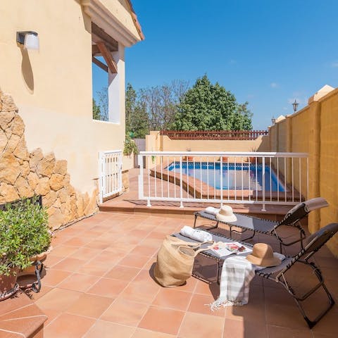Sunbathe on loungers on the terracotta tiled terrace