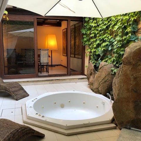 Bathe in the intimate outdoor jacuzzi