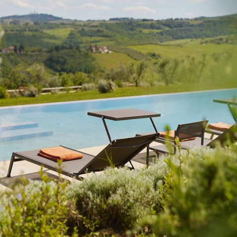 Stretch out poolside with sweeping views across the rolling countryside