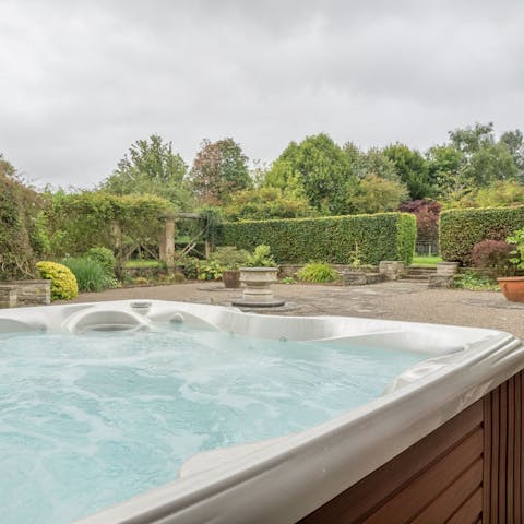 Unwind in the hot tub with a drink