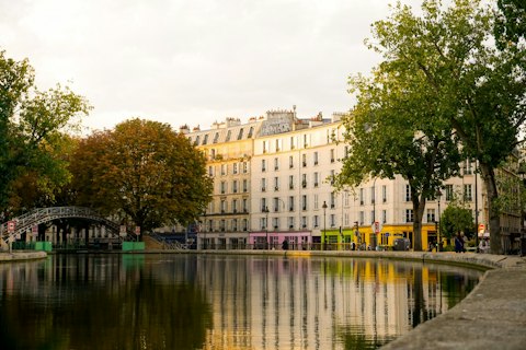 Wander Canal Saint-Martin's iron footbridges and tree-lined towpaths, a ten-minute walk