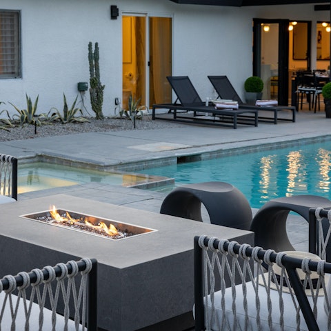 Gather round the poolside fire pit after sunset