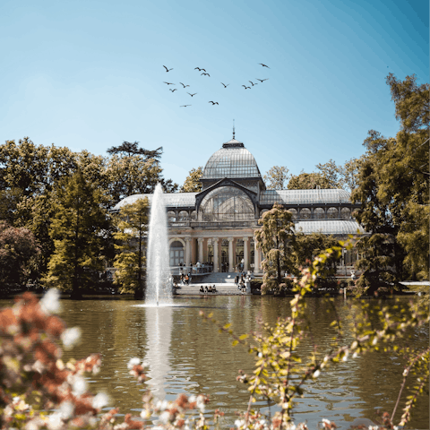 Take an afternoon stroll through El Retiro Park, a ten-minute walk away