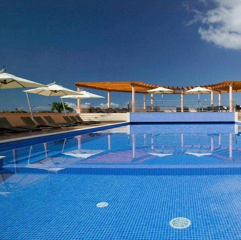 Head over to the communal outdoor pool and relax on a poolside lounger