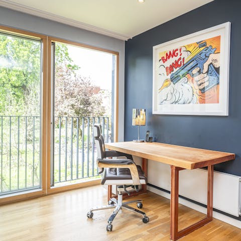 Catch up on work beside floor-to-ceiling windows