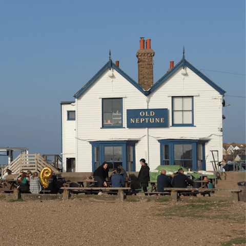 Sip a pint overlooking the sea at Old Neptune, just over 100 yards away