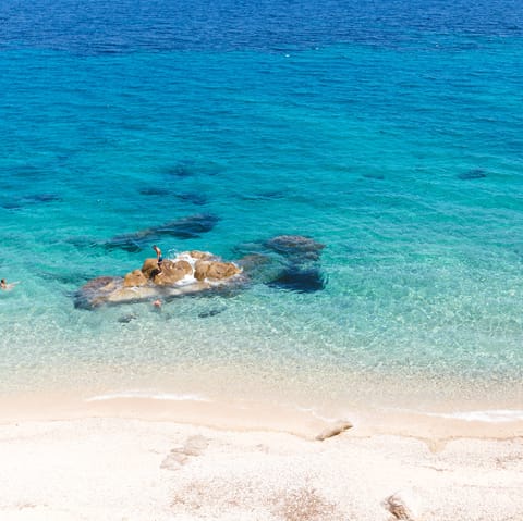 Spend leisurely days at Psarrou Beach, an eight-minute drive away