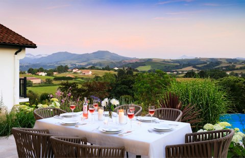Dine at dusk with rolling Pyrenean hills stretching into the distance
