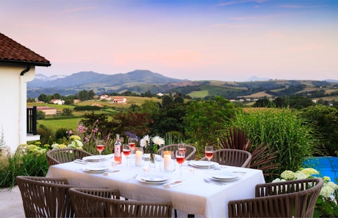 Dine at dusk with rolling Pyrenean hills stretching into the distance