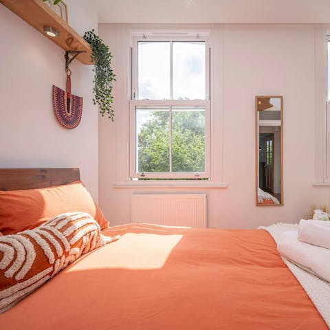 Wake up to leafy views in the comfortable bedroom