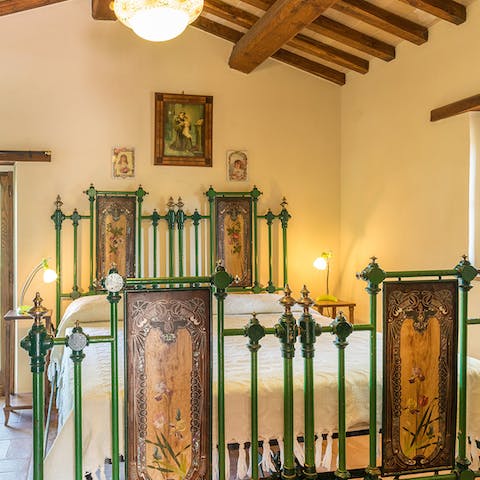 Fall asleep in the elaborate, gothic–inspired bed