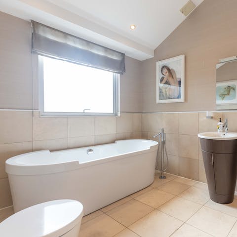 Close your eyes and sink back into soothing water in the freestanding bathtub