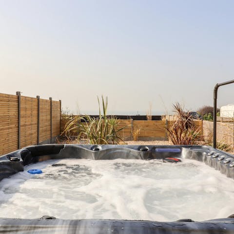 Take a soak in the hot tub while enjoying sea views