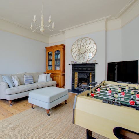 Play table football in one of the two living rooms