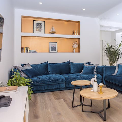 We love the dark velvet sofas and abundant plant life