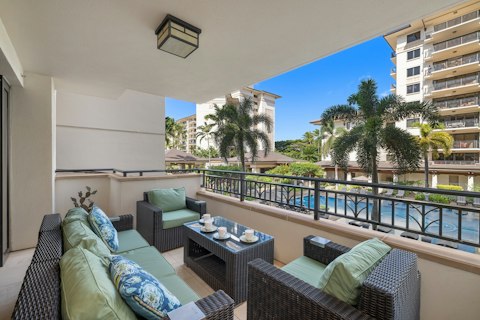 Sit out on the lanai overlooking the pool and palms