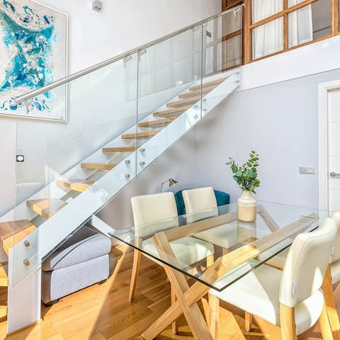 Share intimate meals around the glass dining table