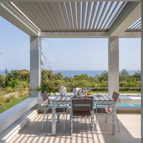 Dine under the dappled sunlight of the verandah and admire the coastal panorama