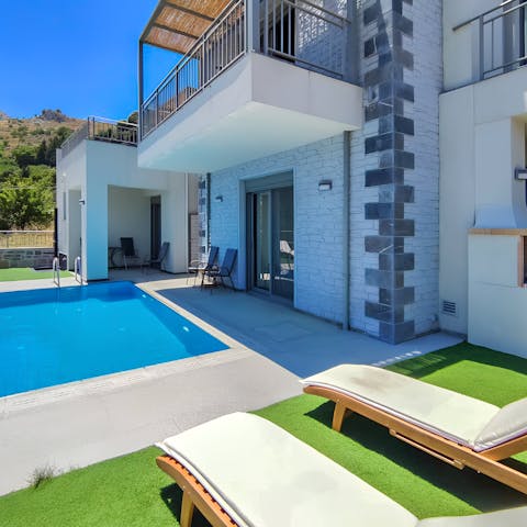 Laze on sun loungers before cooling off with a dip in the private pool
