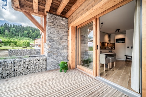 Step outside onto your private terrace framed by Alpine forest
