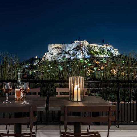 Take in the views from the balcony as the Acropolis lights up the sky