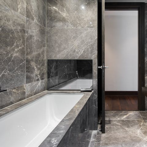 Catch up on your favourite soaps as you luxuriate in the marble-edged tub