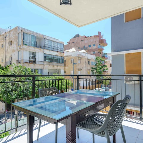 Share a bottle of arak on the sun-soaked balcony