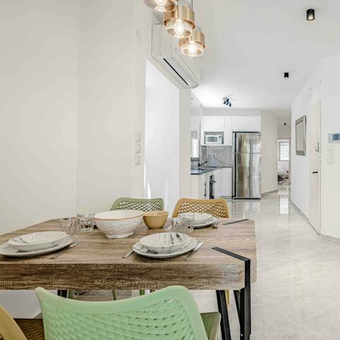 Tuck into dishes of falafel and shawarma on the wooden dining table