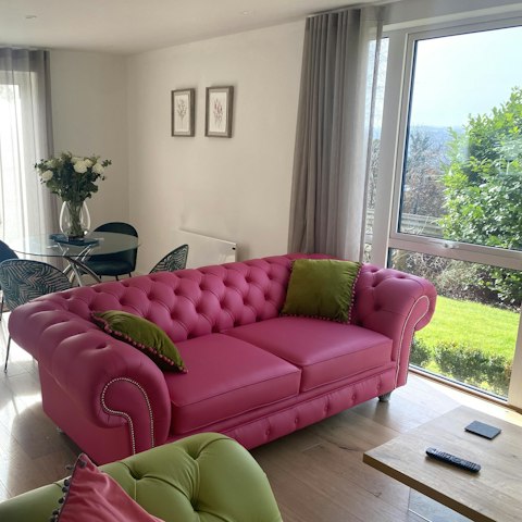 Relax and unwind in the bright living room or step out into your private garden