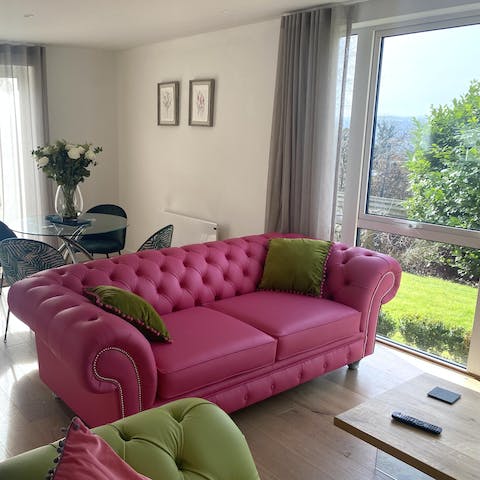 Relax and unwind in the bright living room or step out into your private garden