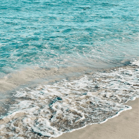 Visit Es Portitxol Beach, a twenty-minute drive away