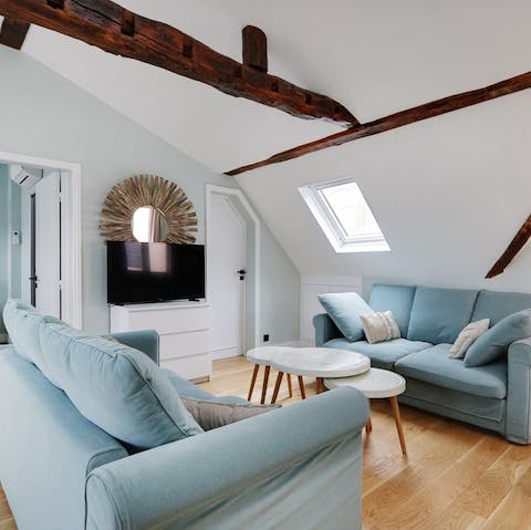 Relax in the beamed living area with a glass of French wine after a busy day of exploring