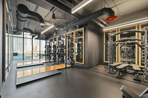 Train in a well-equipped gym with city views beyond
