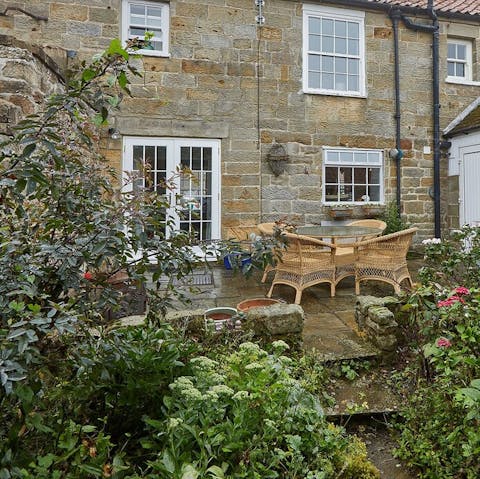 A cute back garden filled with plants