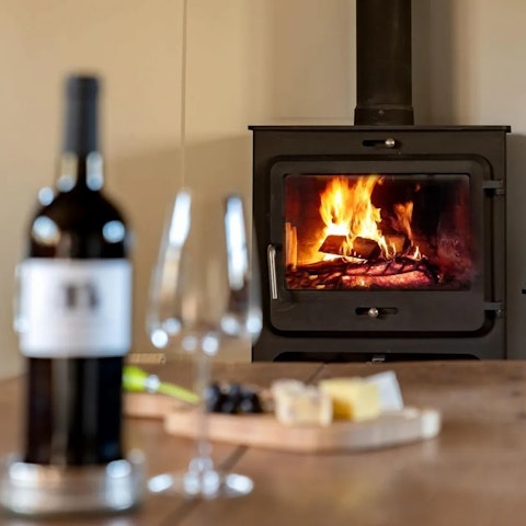 Savour a glass of red wine by the cosy fire