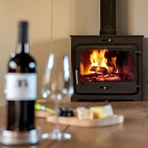 Savour a glass of red wine by the cosy fire