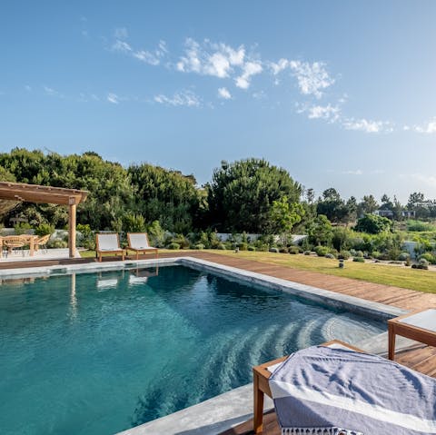 While away sunny afternoons lounging by the pool