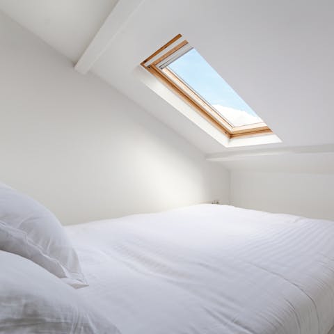 Fall asleep to the city's stars twinkling through the second bedroom's skylight