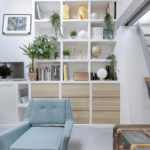 Kick back in the bright living room with a glass of wine and one of the many books from the shelves