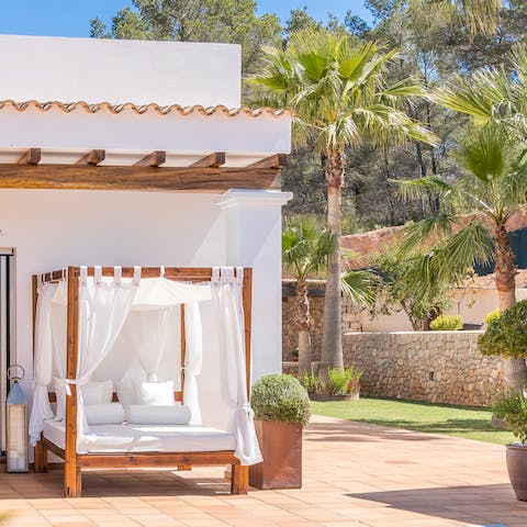 Lounge out on the four-poster day bed with your new summer read