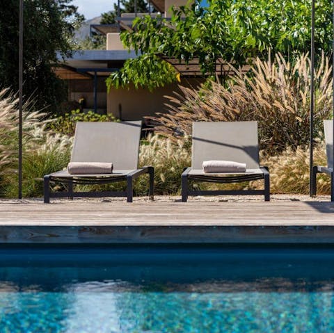 Stretch out by the pool surrounded by lush Mediterranean gardens